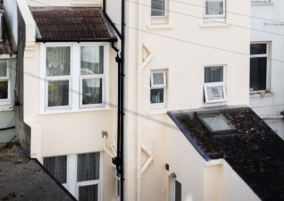 Rear elevation of a British terrace fitted with white casement windows