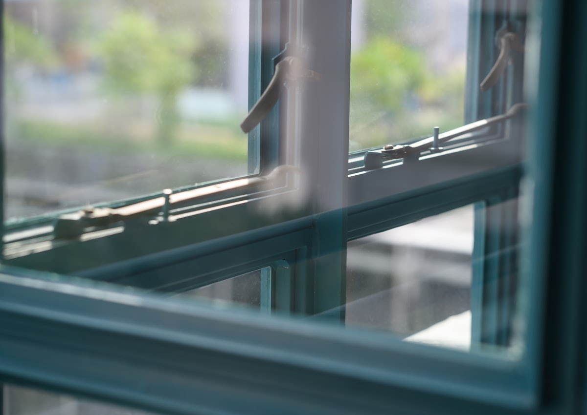 Window opened inwards, showing the hinge and friction stay along the frame